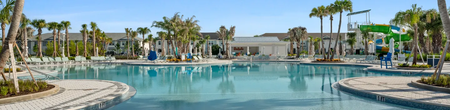 Windsor Cay Resort swimming pool with palms, loungers and water play area