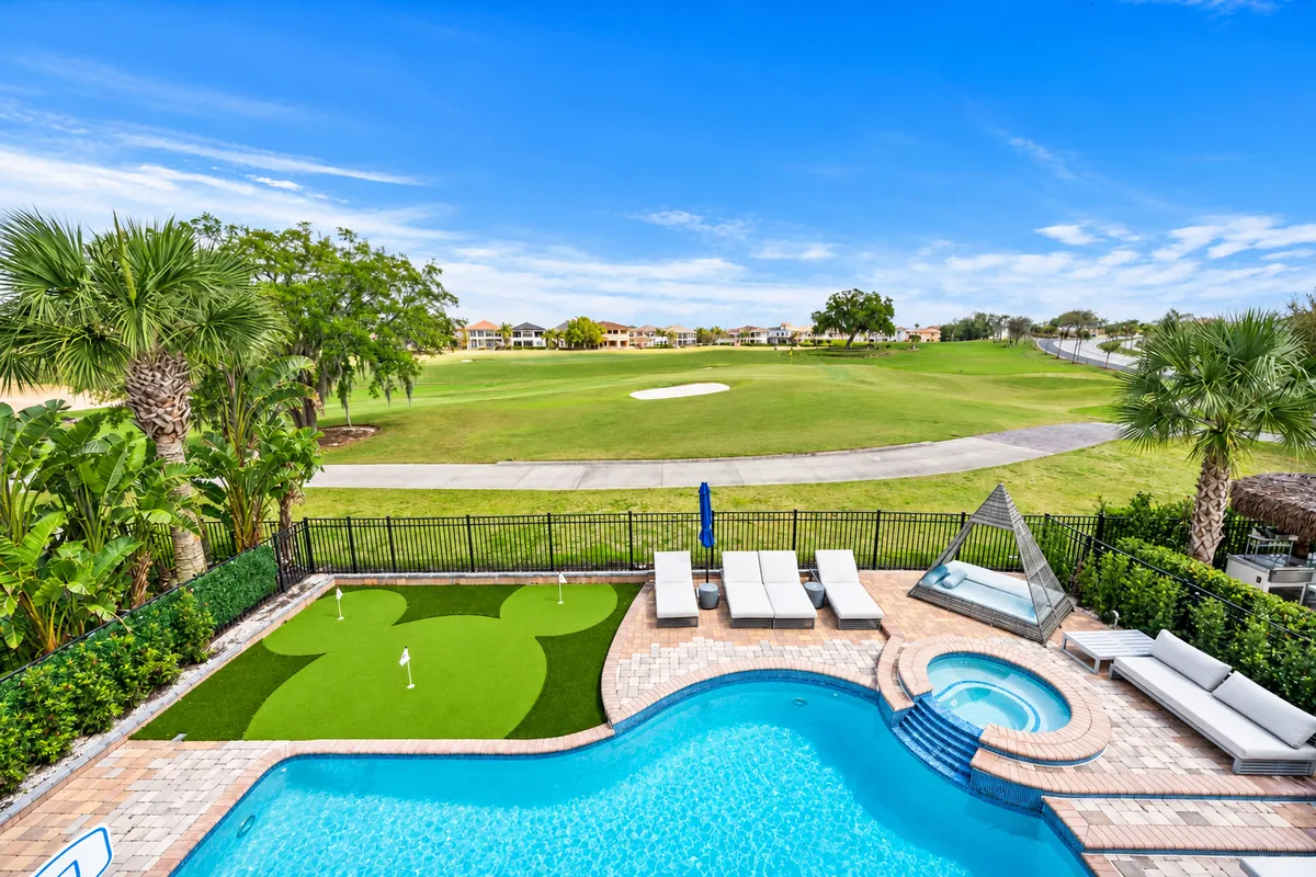 Outdoor pool and putting green at a luxury vacation home