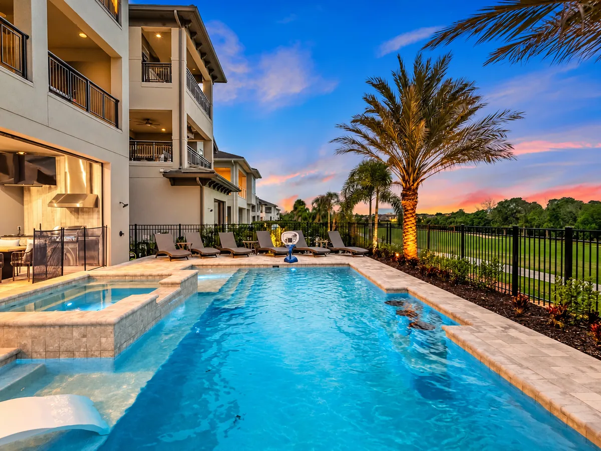 Illuminated private villa and pool at dusk