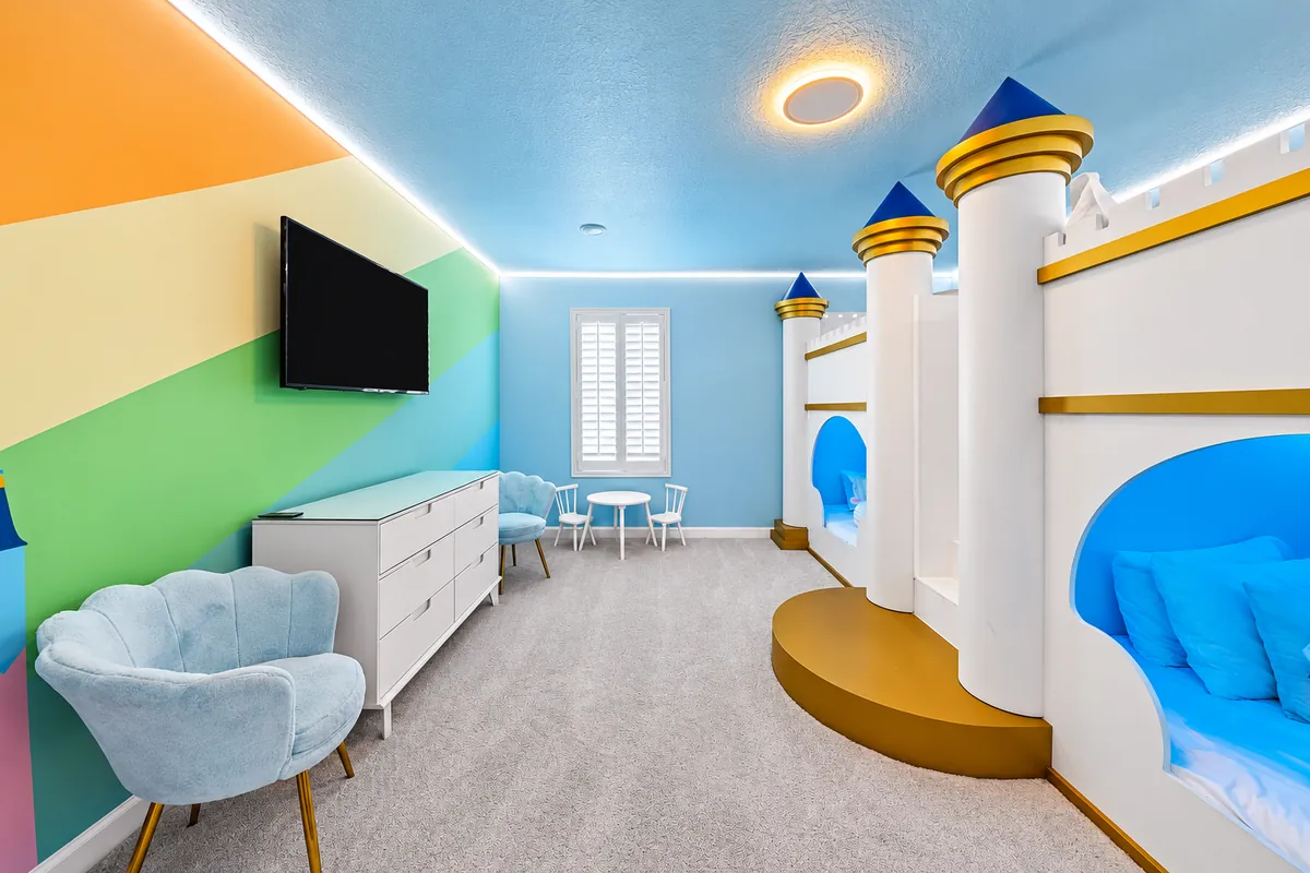 Princess castle themed bedroom with pastel walls and castle-shaped beds