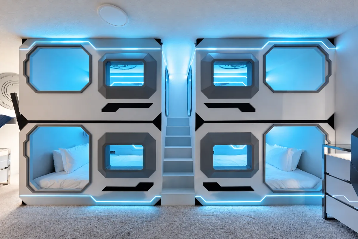 Space themed bunk room with blue lighting
