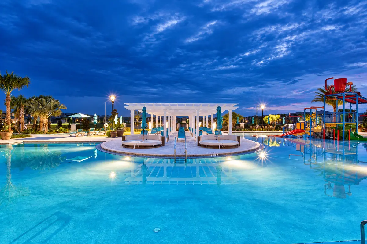 Windsor at Westside resort pool and splash playground at dusk